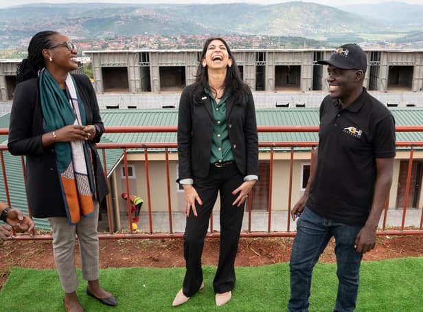 Home Secretary Suella Braverman laughs as she tours a building site on the outskirts of Kigali, Rwanda, where deported migrants are planned to be housed (Picture: Stefan Rousseau/PA)