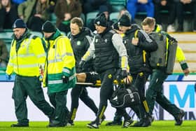 Celtic's Alistair Johnston is taken off on a stretcher against Hibs.