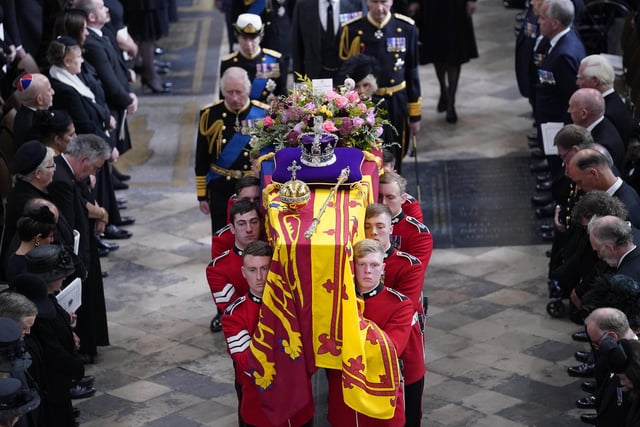 King Charles III, the Queen Consort, the Princess Royal and Vice Admiral Sir Tim Laurence follow behind the coffin of Queen Elizabeth II, draped in the Royal Standard with the Imperial State Crown and the Sovereign's orb and sceptre, as it is carried out of Westminster Abbey after her State Funeral. Picture date: Monday September 19, 2022.