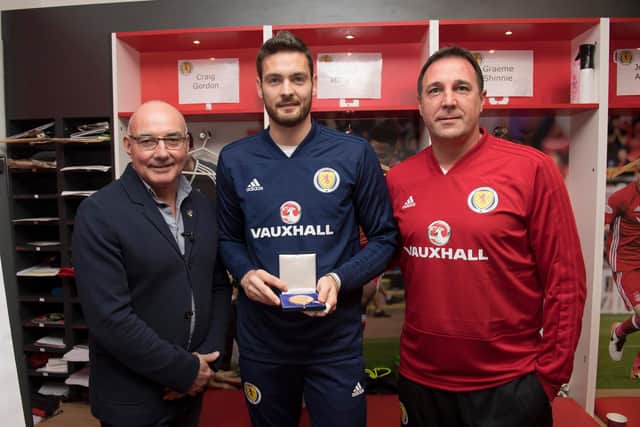 Craig Gordon (centre) receives his 50th cap medal from Willie Miller (left) and Scotland interim manager Malky Mackay before the friendly against the Netherlands at Pittodrie in 2017