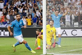 Israel's forward Munas Dabbur scores his country's second goal against Austria.