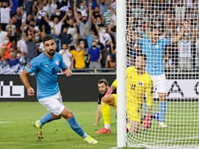 Israel's forward Munas Dabbur scores his country's second goal against Austria.