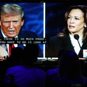 People watch the ABC News presidential debate between Democratic presidential nominee, U.S. Vice President Kamala Harris and Republican presidential nominee, former U.S. President Donald Trump at a debate watch party (Photo by Mario Tama/Getty Images)
