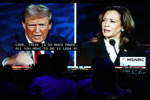 People watch the ABC News presidential debate between Democratic presidential nominee, U.S. Vice President Kamala Harris and Republican presidential nominee, former U.S. President Donald Trump at a debate watch party (Photo by Mario Tama/Getty Images)