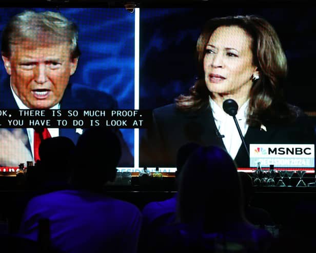 People watch the ABC News presidential debate between Democratic presidential nominee, U.S. Vice President Kamala Harris and Republican presidential nominee, former U.S. President Donald Trump at a debate watch party (Photo by Mario Tama/Getty Images)