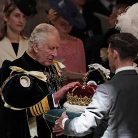 King Charles III is presented with the Crown of Scotland during the National Service of Thanksgiving and Dedication