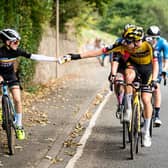 Pascal Eenkhoorn of Team Jumbo–Visma hands a bottle to Xander Graham (Photo: Alex Whitehead/SWpix.com).