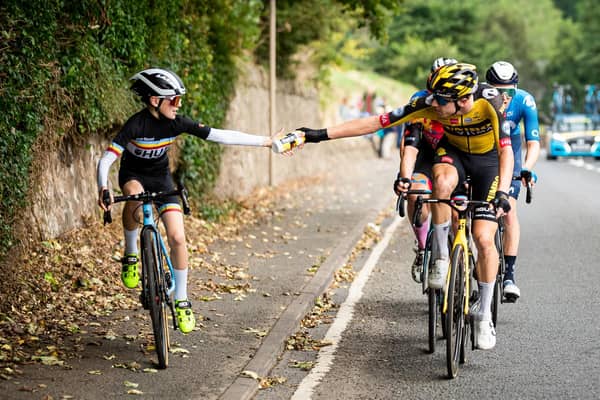 Pascal Eenkhoorn of Team Jumbo–Visma hands a bottle to Xander Graham (Photo: Alex Whitehead/SWpix.com).
