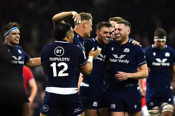 Scotland's Duhan van der Merwe (centre left) celebrates scoring his side's third try of the game with team-mates during the Guinness Six Nations match at the Principality Stadium, Cardiff. Picture date: Saturday February 3, 2024.
