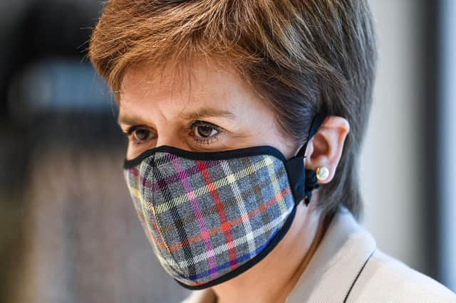 First Minister Nicola Sturgeon wears a face mask before she was pictured without one