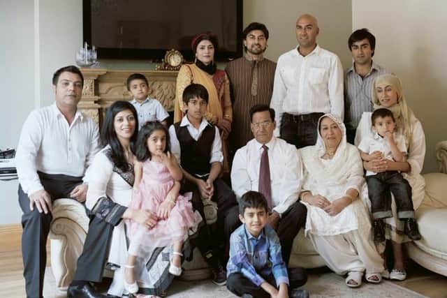 Amar Latif (standing in white shirt) with his family in Glasgow earlier this year. Picture: Verena Jaekel