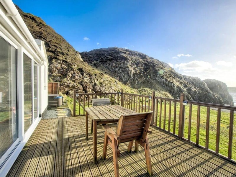 The decked area is accessed from the sun room and is the perfect place to unwind with a glass of wine on a sunny evening.