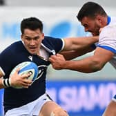 Scotland centre Sam Johnson holds off Italy tighthead prop Giosue Zilocchi during the Nations Cup win in Florence.