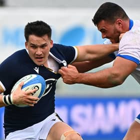 Scotland centre Sam Johnson holds off Italy tighthead prop Giosue Zilocchi during the Nations Cup win in Florence.