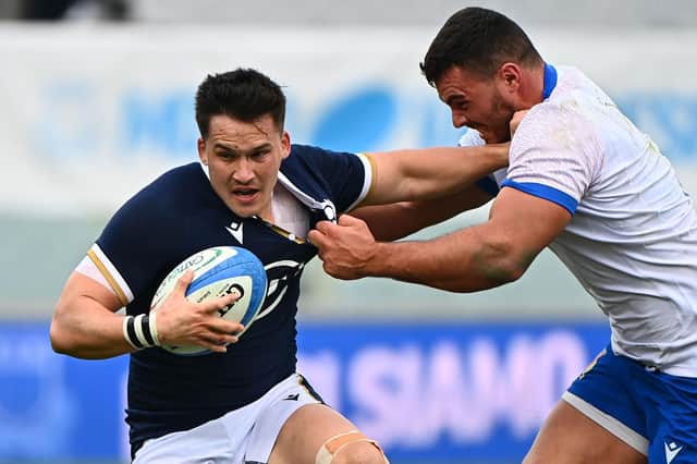 Scotland centre Sam Johnson holds off Italy tighthead prop Giosue Zilocchi during the Nations Cup win in Florence.
