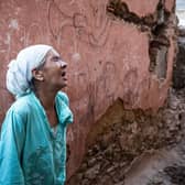 A woman reacts standing in front of her earthquake-damaged house in the old city in Marrakesh. (Pic: Fadel Senna/AFP via Getty Images)