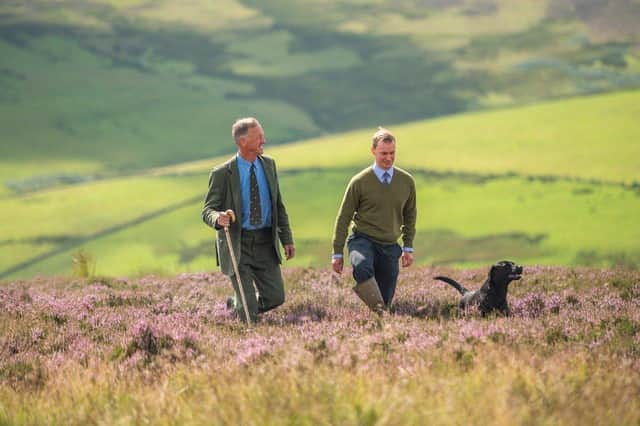 Assistant Factor Ed Brown (green jumper) and Headkeeper Drew Ainslie (blue shirt and tie) pictured on the heather filled moorland at Byrecleugh Moor, owned by Roxburghe Estates, inspecting the health of the moorland ahead of the glorious 12th August grouse shooting season (Photo: Phil Wilkinson).