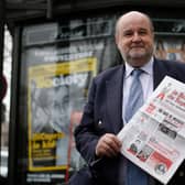 Editor Vicomte Jean d'Indy, pictured here in 2016, holds a copy of the leap year publication La Bougie du Sapeur, which has been running since 1980 and has only published 12 issues. Picture: AFP via Getty Images