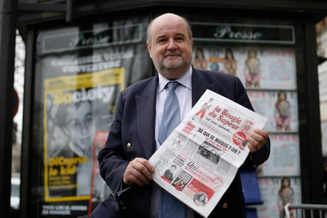 Editor Vicomte Jean d'Indy, pictured here in 2016, holds a copy of the leap year publication La Bougie du Sapeur, which has been running since 1980 and has only published 12 issues. Picture: AFP via Getty Images