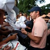 Rory McIlroy signs autographs for excited young fans following the third round of the BMW PGA Championship at Wentworth. Picture: Luke Walker/Getty Images.