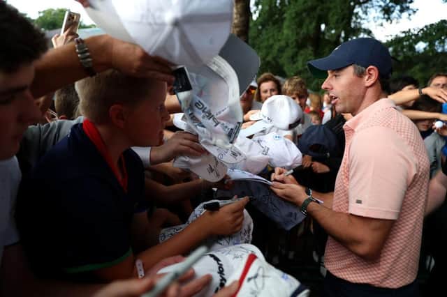 Rory McIlroy signs autographs for excited young fans following the third round of the BMW PGA Championship at Wentworth. Picture: Luke Walker/Getty Images.