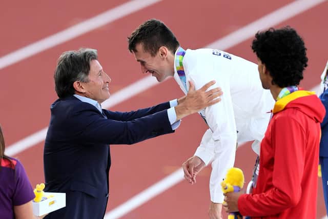 Jake Wightman is presented with his gold medal by World Athletics President Sebastian Coe. (Photo by Andy Lyons/Getty Images for World Athletics)