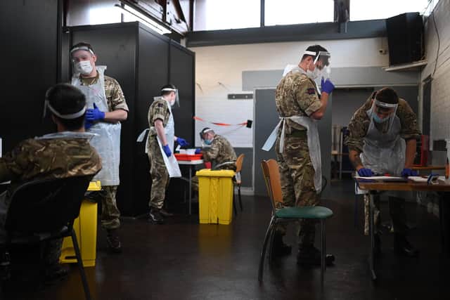 British Army soldiers, 1st battalion Coldstream Guards, staff a coronavirus testing centre set up at the Merseyside Caribbean Council Community Centre in Liverpool, north west England, on November 10, 2020 during a city-wide mass testing pilot operation. Picture: Oli Scarff/AFP via Getty Images