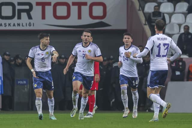 Scotland's John McGinn, centre, celebrates with teammates after scoring in the 2-1 defeat to Turkey. (AP Photo)