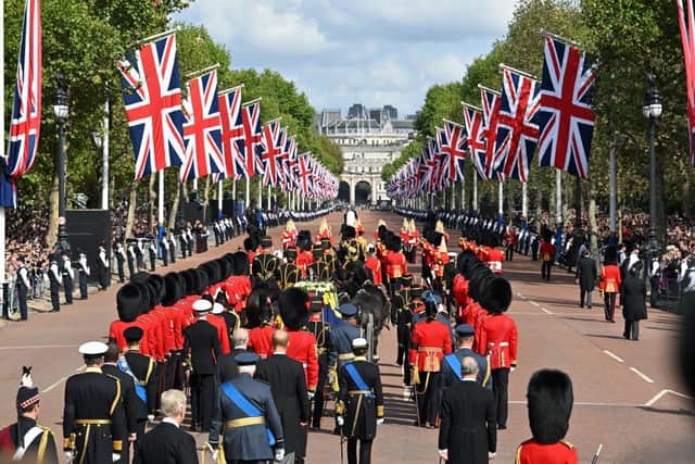 The Queen’s funeral cortege makes its way along The Mall from Buckingham Palace during the procession for the Lying-in State of Queen Elizabeth II on September 14, 2022.