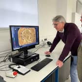 Professor Paul N Pearson, left, and Jesper Ericsson, of The Hunterian, University of Glasgow, looking at the Sponsian coin under a microscope