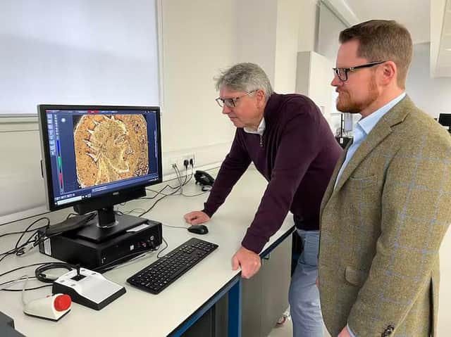 Professor Paul N Pearson, left, and Jesper Ericsson, of The Hunterian, University of Glasgow, looking at the Sponsian coin under a microscope