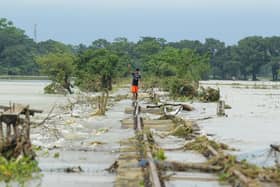 A boy walks on a damaged railway track in Sunamganj, Bangladesh, where climate change has increased the frequency of floods (Picture: Mamun Hossain/AFP via Getty Images)