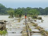 A boy walks on a damaged railway track in Sunamganj, Bangladesh, where climate change has increased the frequency of floods (Picture: Mamun Hossain/AFP via Getty Images)
