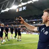 Scotland's flanker Hamish Watson takes a selfie with supporters after Scotland defeated Romania.