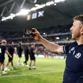 Scotland's flanker Hamish Watson takes a selfie with supporters after Scotland defeated Romania.