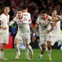 Poland celebrate after victory in the penalty shoot out over Wales in the Euro 2024 play-off final in Cardiff. (Photo by Richard Heathcote/Getty Images)