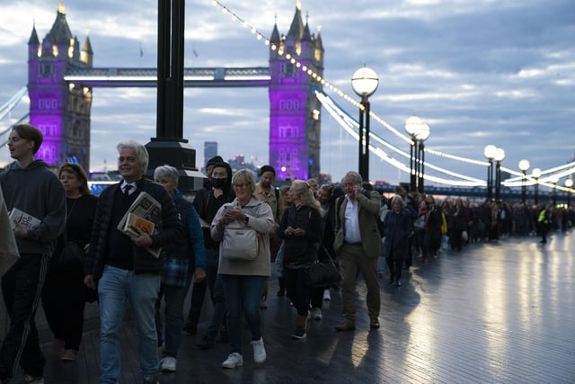 Members of the public in the queue at 06:09 on The Queen's Walk by Tower Bridge in London, as they wait to view Queen Elizabeth II lying in state ahead of her funeral on Monday. Picture date: Friday September 16, 2022.