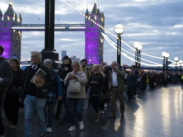 Members of the public in the queue at 06:09 on The Queen's Walk by Tower Bridge in London, as they wait to view Queen Elizabeth II lying in state ahead of her funeral on Monday. Picture date: Friday September 16, 2022.