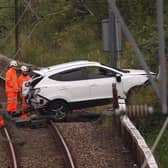 Rail workers recover the vehicle from the tracks. Pic: John Devlin.