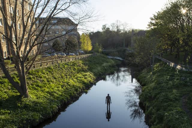 One of artist Antony Gormley's "6 TIMES" statues in the Water of Leith, Edinburgh, as sweltering temperatures are expected to hit the UK at the end of the week bringing the hottest April in almost a decade.