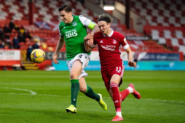 Hibs' Paul Hanlon competes with Ryan Hedges during the  match which decided the teams league fate this term. Photo by Mark Scates / SNS Group