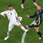 Scotland's Callum McGregor challenges with Germany's Pascal Gross during the Euro 2024 opener in Munich. (Photo by THOMAS KIENZLE/AFP via Getty Images)