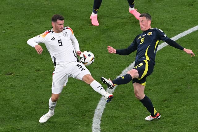 Scotland's Callum McGregor challenges with Germany's Pascal Gross during the Euro 2024 opener in Munich. (Photo by THOMAS KIENZLE/AFP via Getty Images)