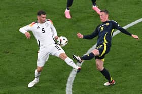 Scotland's Callum McGregor challenges with Germany's Pascal Gross during the Euro 2024 opener in Munich. (Photo by THOMAS KIENZLE/AFP via Getty Images)