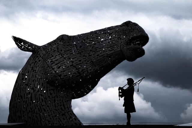 Piper Mark Sutherland, from Larbert standing in the shadow of Andy Scott's magnificent sculptures.