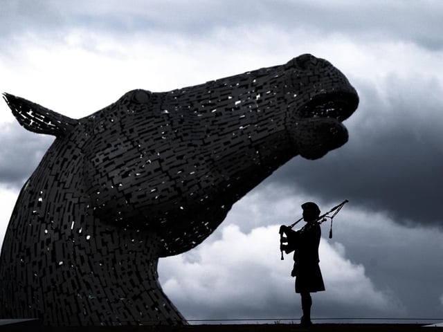 Piper Mark Sutherland, from Larbert standing in the shadow of Andy Scott's magnificent sculptures.