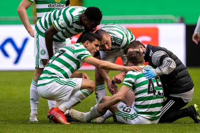 James Forrest is surrounded by Celtic team-mates after pulling up in the win over Livingston. Picture: SNS