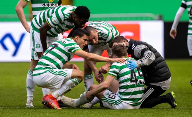 James Forrest is surrounded by Celtic team-mates after pulling up in the win over Livingston. Picture: SNS