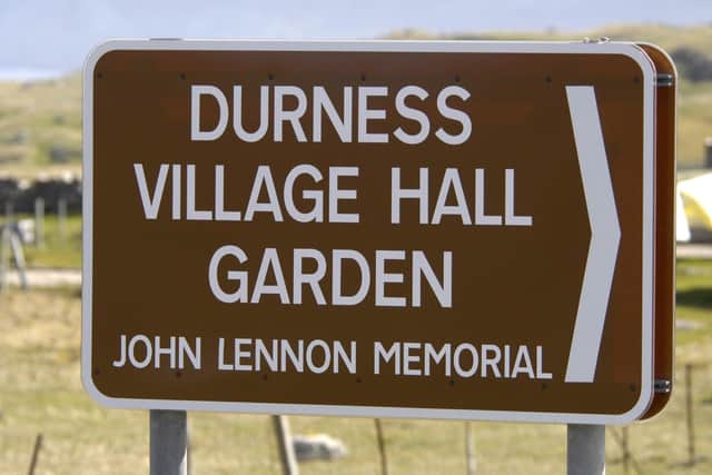 Sign post for the Durness village hall garden and John Lennon memorial, Durness, Scotland.