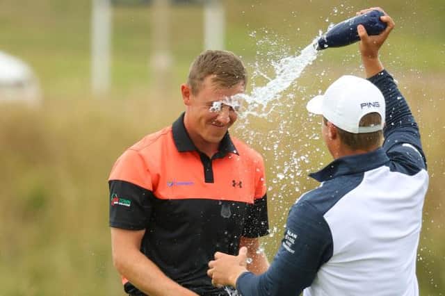 Grant Forrest celebrates his Hero Open victory on the 18th green with Calum Hill after the pair had played together in the final round at Fairmont St Andrews. Picture: Andrew Redington/Getty Images.